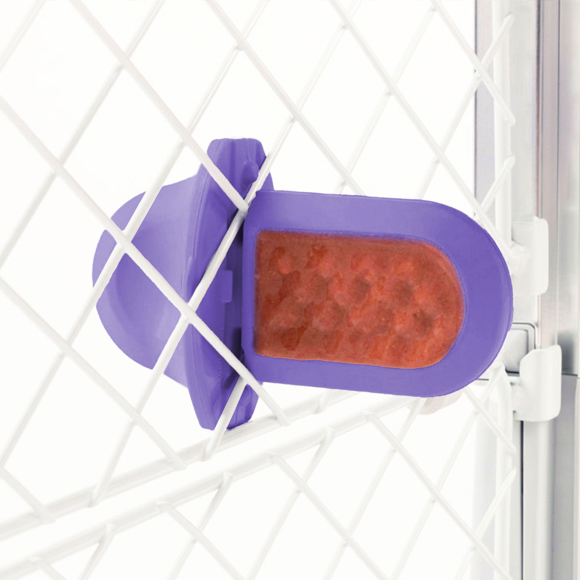 A Lavender Groov Training Aid attached to a white dog crate
