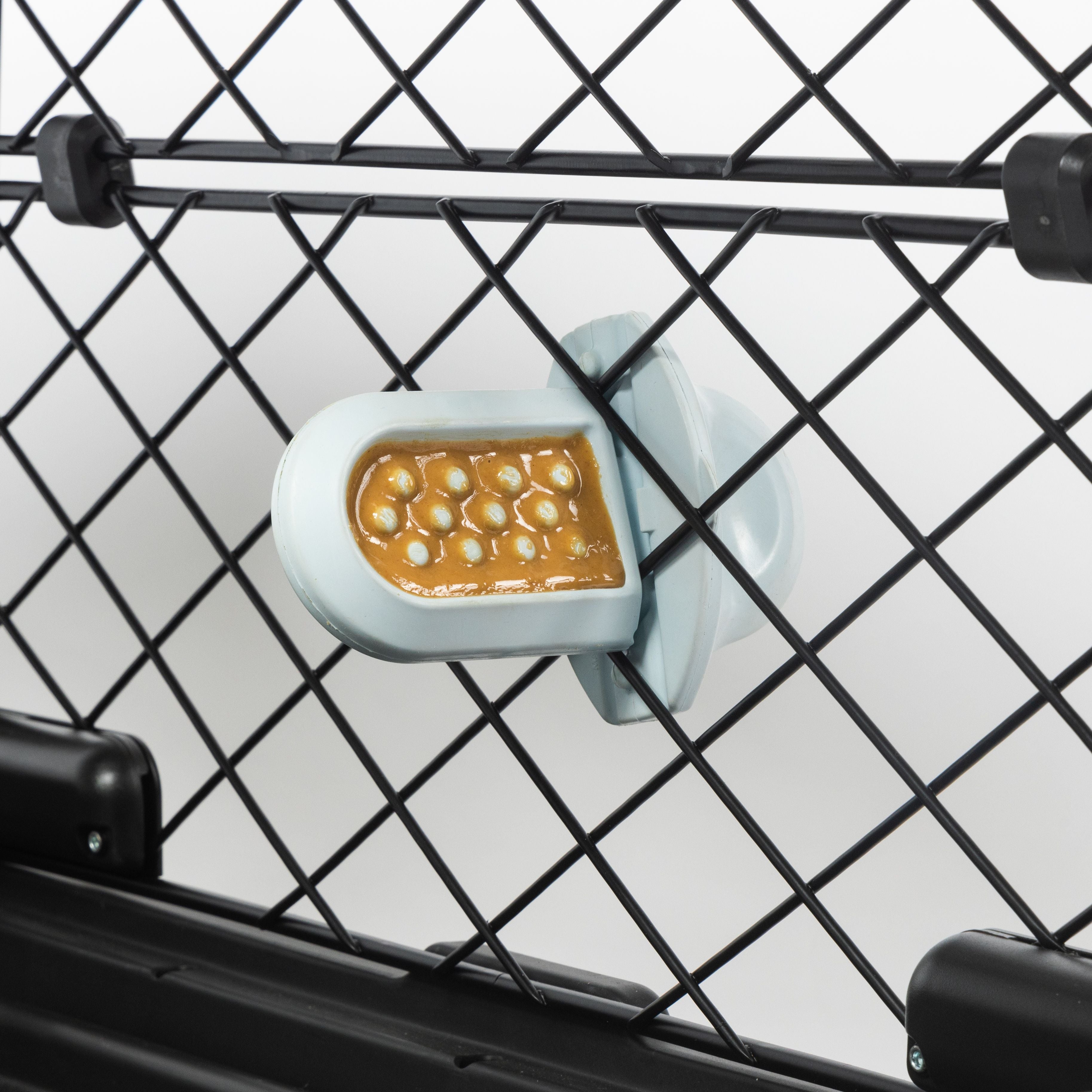 an ice Groov inserted into a Revol crate with peanut butter spread on it