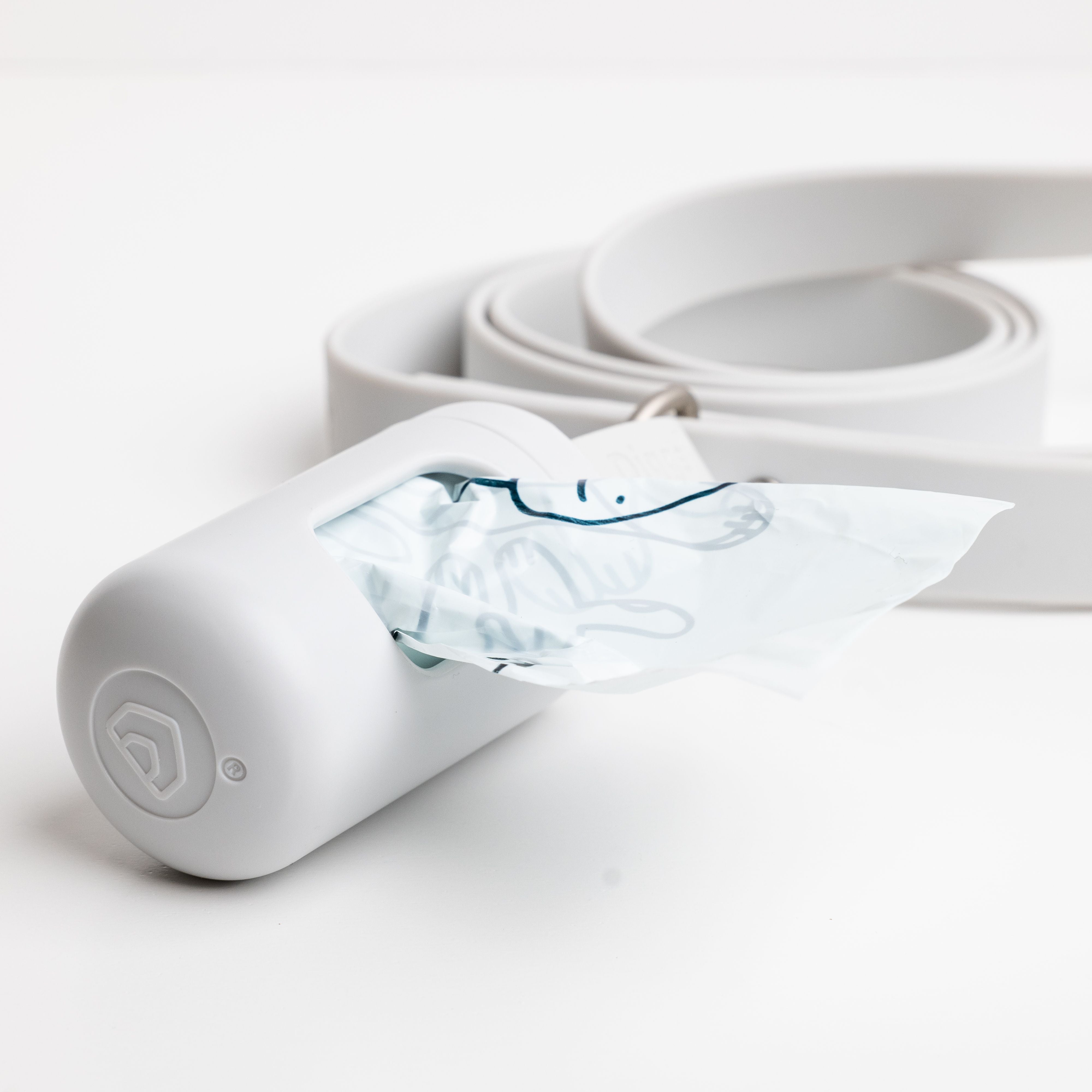 an ash dispenser with a poop bags on a white background