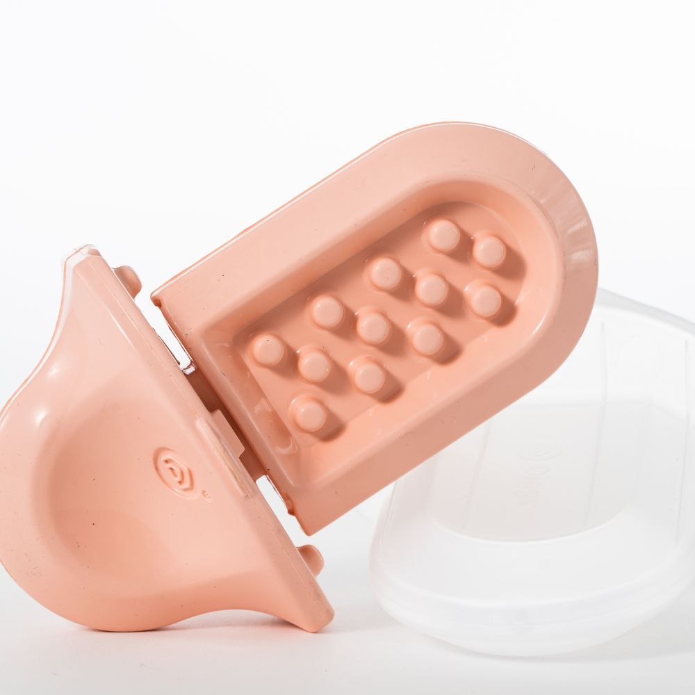 a close up of a Blush Groov next to its freezer shell on a white background