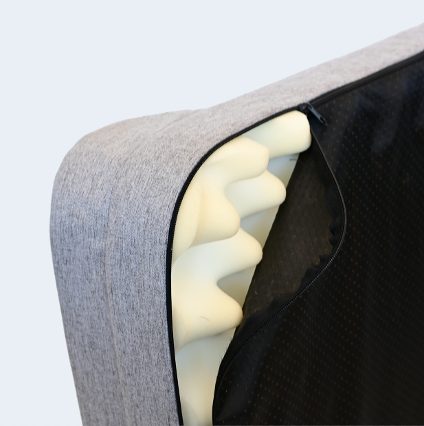 Side view of Bolstr dog bed, with cover partially unzipped to show memory foam inside.